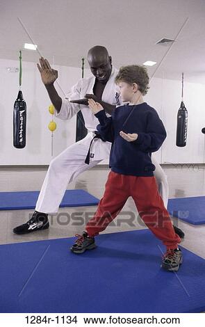 Picture - multiethnic, instructing, teacher, sports, child, beginnings. Fotosearch