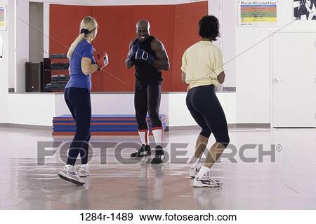 Stock Photo - multiethnic, people, sports, exercise, exercising, punching. Fotosearch