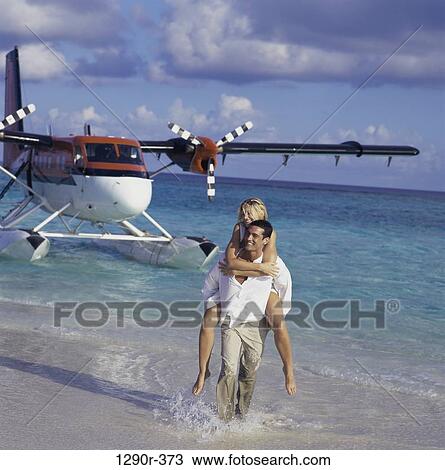 Stock Image - people, airplane, couple, beach, clothed. Fotosearch