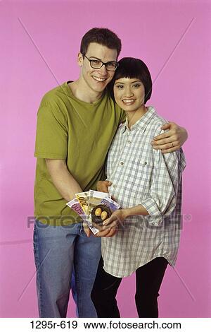 Stock Photo - people, Asian, couple, hugging, hug, brunette, expecting. Fotosearch