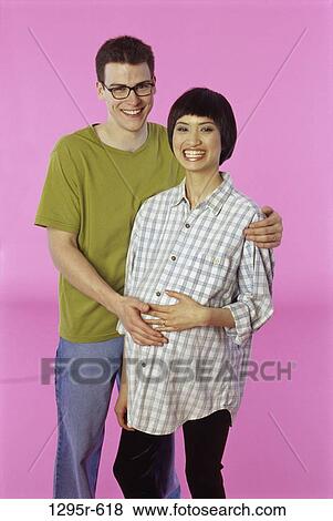 Stock Photo - people, Asian, couple, joyous, expecting, pregnancy, indoors. Fotosearch