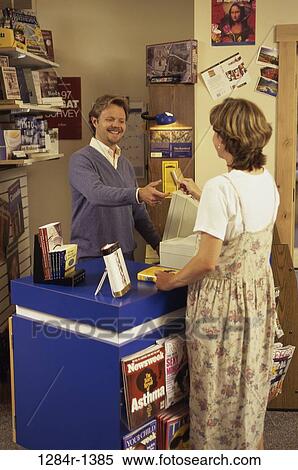 Stock Photography - people, books, shopping, credit, cashier, checkout, paying. Fotosearch