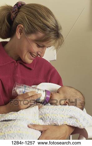people, bottle, mother, baby, holding, family, feeding View Large Photo Image Stock Photo - people, bottle, mother, baby, holding, family, feeding. Fotosearch