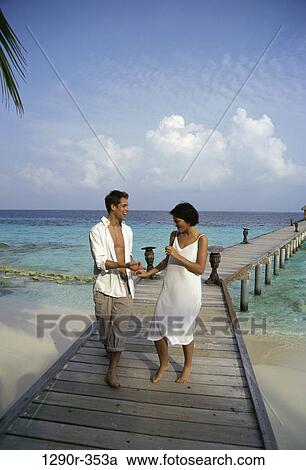 Stock Image - people, couple, beach, dock, clothed, pier. Fotosearch