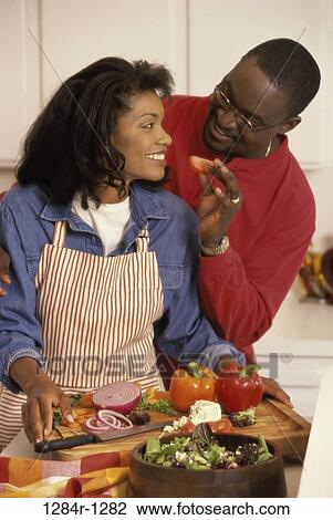 Stock Image - people, couple, salad, cooking, Middle-aged, food, apron. Fotosearch