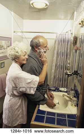 Stock Photograph - people, couple, senior, flirting, shaving, shaving cream, sink. Fotosearch