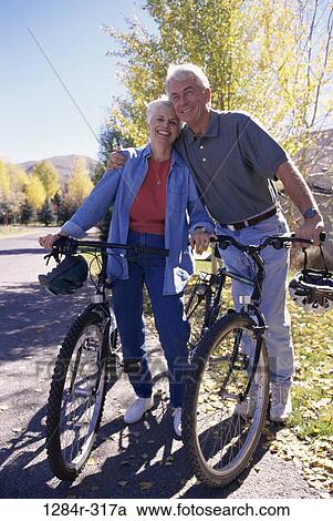 Stock Image - people, couple, senior, outdoors, exercise, bicycles, Caucasian. Fotosearch