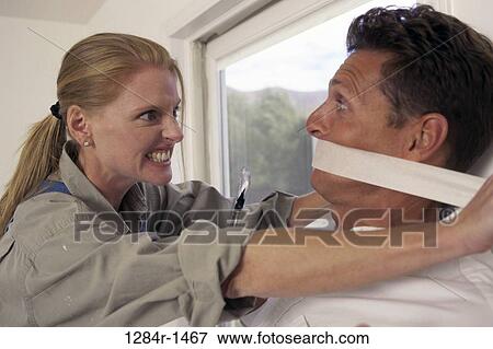 Stock Photo - people, couple, tape, mouth, angry, indoors. Fotosearch