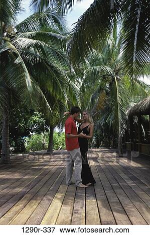 Stock Photo - people, couple, tropical, beach, dancing, dance, outdoors. Fotosearch