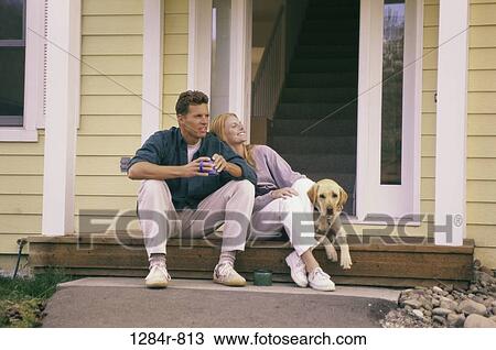 people, dog, couple, door, sitting, pet View Large Photo Image Stock Image - people, dog, couple, door, sitting, pet. Fotosearch