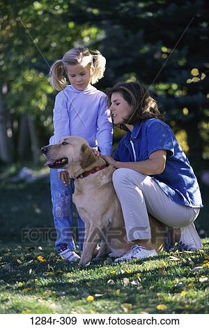 Stock Photo - people, dog, mother, pet, outdoors, family, daughter. Fotosearch