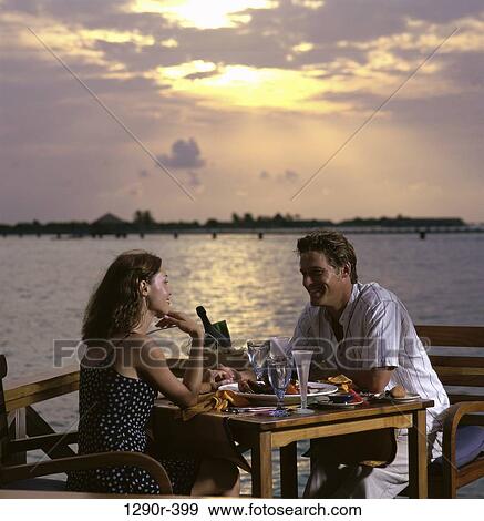 Stock Photo - people, eating, couple, beach, romantic, dinner. Fotosearch