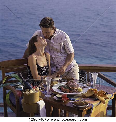 Stock Image - people, eating, water, couple, champagne, drinking. Fotosearch