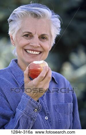 people, eating, woman, senior, healthy, apple, outdoors View Large Photo Image Stock Image - people, eating, woman, senior, healthy, apple, outdoors. Fotosearch