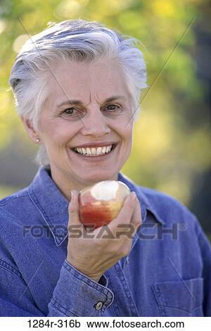 people, eating, woman, senior, healthy, apple, outdoors View Large Photo Image Stock Image - people, eating, woman, senior, healthy, apple, outdoors. Fotosearch