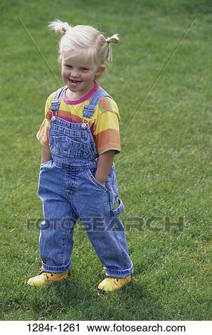 Stock Image - people, girl, outdoors, child, blond, overalls. Fotosearch