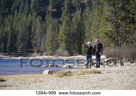 Stock Photo - people, hands, water, walking, couple, senior. Fotosearch