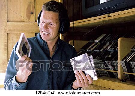 Stock Photo - people, headset, listening, music, Middle-aged, indoors. Fotosearch
