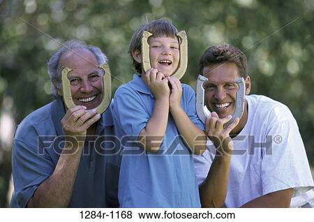 Stock Photo - people, holding, three, outdoors, family. Fotosearch