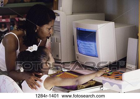Stock Image - people, home, mother, computer, family, daughter. Fotosearch