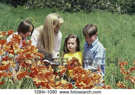 Stock Image - people, mother, book, flowers, outdoors, garden. Fotosearch