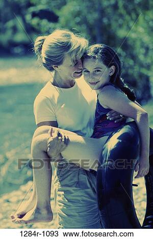 people, mother, inner tube, outdoors, carrying, family, daughter View Large Photo Image Stock Image - people, mother, inner tube, outdoors, carrying, family, daughter. Fotosearch