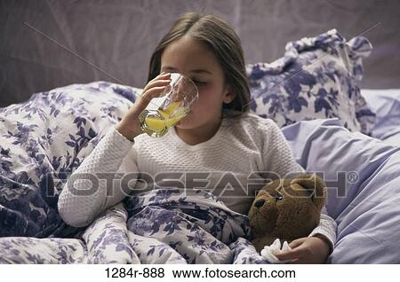 Stock Photo - people, orange juice, bed, drinking, girl, cold. Fotosearch