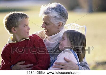 Stock Image - people, outdoors, hugging, family, hug, grandmother, grandparent. Fotosearch