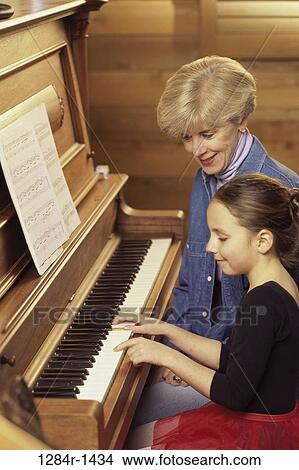 Picture - people, playing, piano, family, play, grandchild. Fotosearch