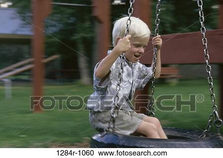 Stock Image - people, playing, swinging, swing, playground, boy. Fotosearch