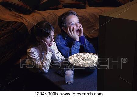 Stock Image - people, popcorn, entertainment, watching, television, children. Fotosearch