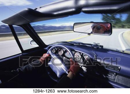 Stock Image - people, reflection, road, car, driving, convertible. Fotosearch