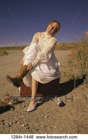 Stock Photo - people, relaxation, woman, sitting, shoes, outdoors, individuality. Fotosearch