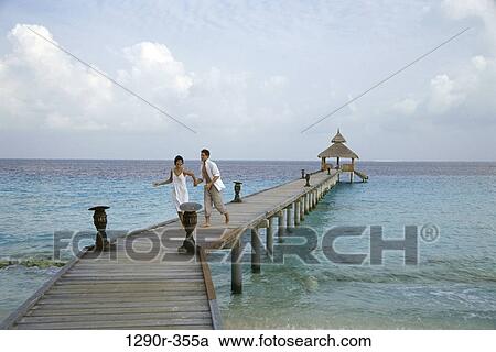 people, running, couple, beach, dock, clothed View Large Photo Image Stock Image - people, running, couple, beach, dock, clothed. Fotosearch