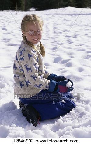 Stock Image - people, snow, eyeglasses, sitting, winter, sweater, girl. Fotosearch