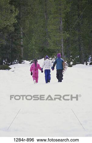 Stock Photograph - people, snow, walking, winter, trees, outdoors, friends. Fotosearch