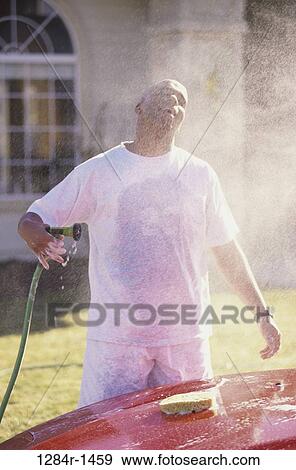 Stock Photo - people, spraying, car, outdoors, transportation, wet. Fotosearch