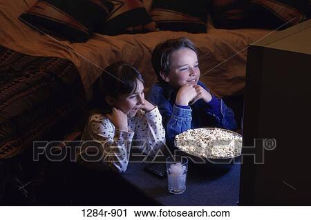 Stock Image - people, staring, popcorn, watch, entertainment, watching. Fotosearch
