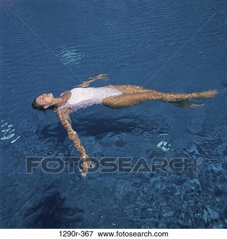 Stock Photo - people, swim, floating, woman, swimming, beach. Fotosearch