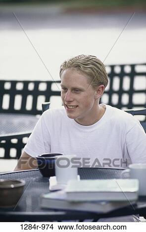Picture - people, table, male, sitting, cafe, outdoors, blond. Fotosearch
