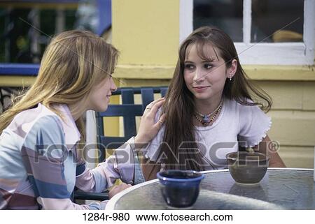 Stock Image - people, table, talking, sitting, outdoors, friends. Fotosearch