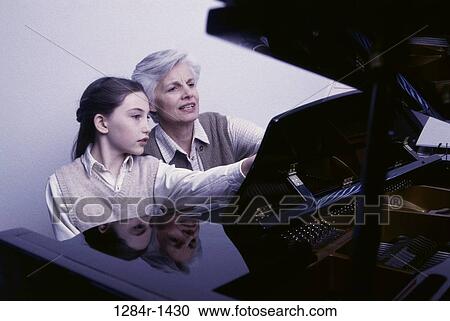 Stock Image - people, teacher, music, piano, family, teaching, grandchild. Fotosearch
