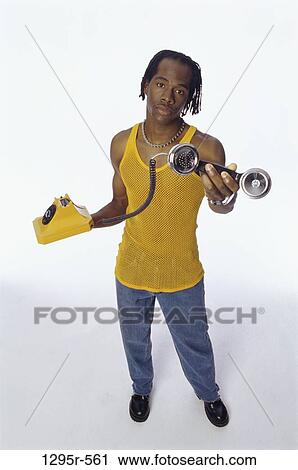 Stock Image - people, telephone, phone, holding, hold, indoors. Fotosearch
