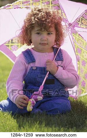 Stock Photo - people, umbrella, pink, shade, holding, girl, outdoors. Fotosearch