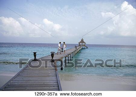 people, walking, couple, beach, dock, clothed View Large Photo Image Stock Image - people, walking, couple, beach, dock, clothed. Fotosearch