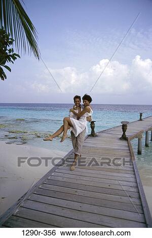 Stock Photograph - people, walking, couple, beach, romantic, dock, carrying. Fotosearch