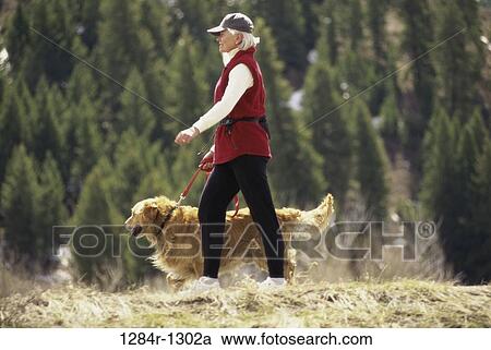 Stock Image - people, walking, dog, pet, outdoors, exercise. Fotosearch
