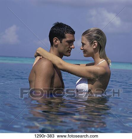 people, water, couple, beach, embracing View Large Photo Image Stock Image - people, water, couple, beach, embracing. Fotosearch
