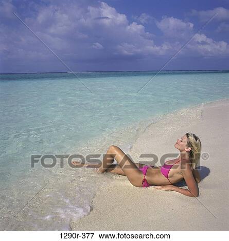 Stock Photo - people, woman, beach, sunbathing, Caucasian. Fotosearch