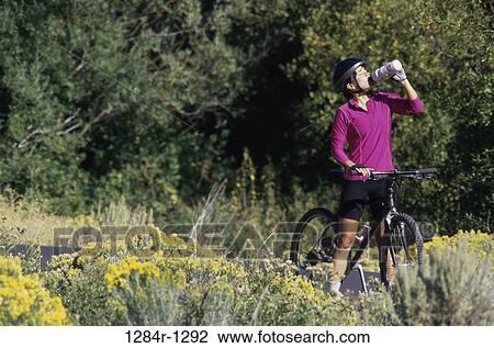 people, woman, bicycle, drinking, outdoors, resting View Large Photo Image Stock Image - people, woman, bicycle, drinking, outdoors, resting. Fotosearch